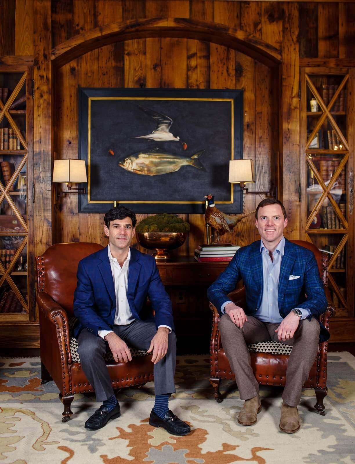 Photo of Worth Jones and William Ware sitting on chairs in wood panel wall office